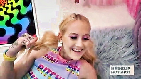 Aubrey Marie blonde with pigtails smiling in graphic top