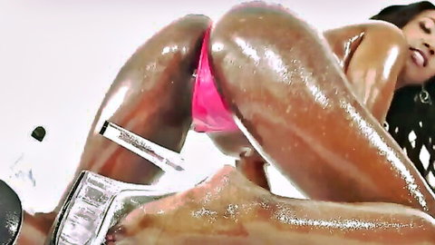 Curvy black woman with big wet oiled ass in pink thong and heels, teasing pose