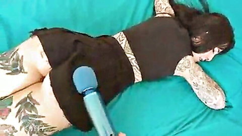 Tattooed babe Awlivv masturbating with vibrator under skirt on bed