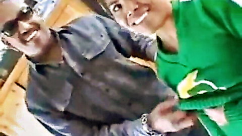 Smiling man in sunglasses embraces skinny woman in green banana top selfie
