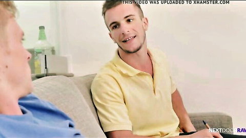 Two athletic white guys in casual shirts on couch, gay blackmail blowjob setup