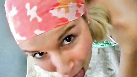 Charming blonde teen in red bandana smiles playfully in lacy top