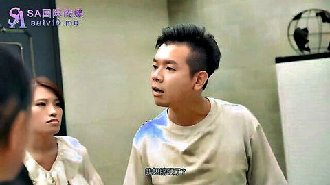 Clothed young Asian man and woman in intense face-to-face conversation in office room