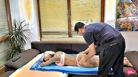 Tattooed blonde bombshell receives oily massage on her curves