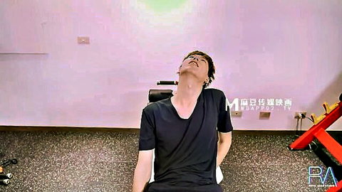 Fit Taiwanese man in black t-shirt, arched neck pose in gym, from Taiwan Sex Gym adult scene