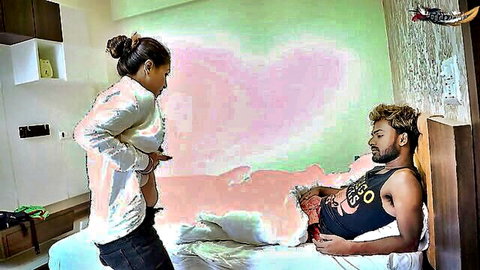 South Asian woman in shiny top watches man stroke his hard cock on bedroom bed