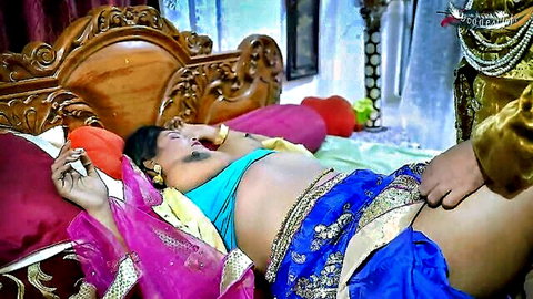Indian woman in sexy saree lying on bed with man's hand groping her thigh near pussy
