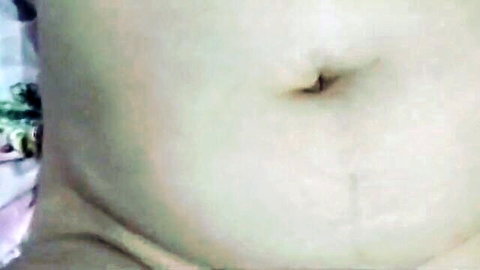 Close-up of sexy plump belly with deep navel and stretch marks