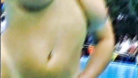 Busty topless woman exposing huge hanging tits and belly by the pool