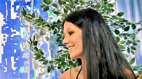 Meli Deluxe smiling profile in black lingerie, teasing pose