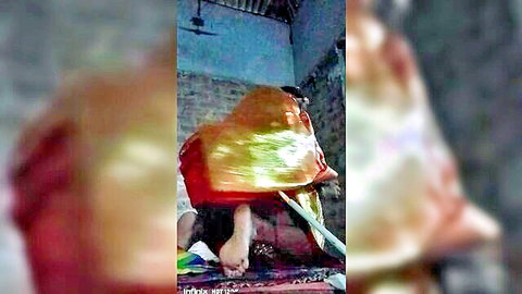 Blurry Indian woman in orange saree, legs exposed in intimate first night pose