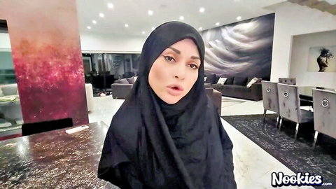 Sexy Arab hijab woman pouting seductively in luxurious living room
