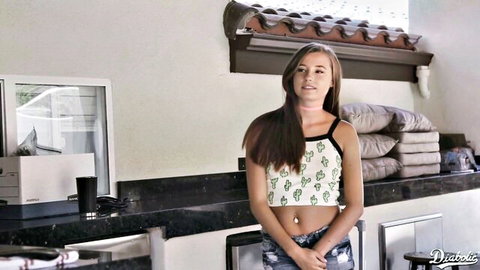 Skinny young brunette teen in tight cactus crop top and low-rise jeans showing navel piercing