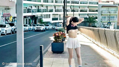 Britney in braless crop top and white mini skirt posing seductively outdoors