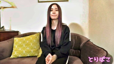 Sad Japanese amateur girl with long purple hair crying on couch in black hoodie