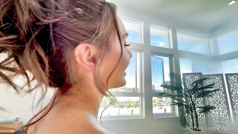 Arabella Rose nude profile view by window, topless brunette beauty