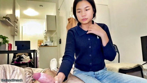 Cute Asian amateur teen in sweater and jeans touching pink dildo on bed