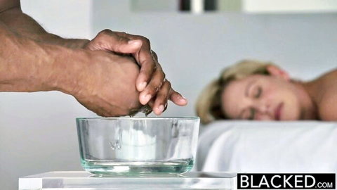 Black hand squeezes milk from busty blonde's breast into bowl, nude asleep
