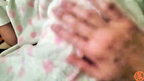 Blurry JAV close-up of hands gripping pink polka-dot fabric