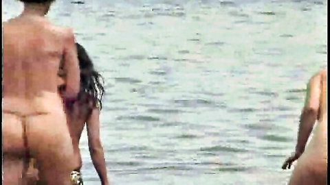 Two curvy Latinas exposing big asses on nude beach