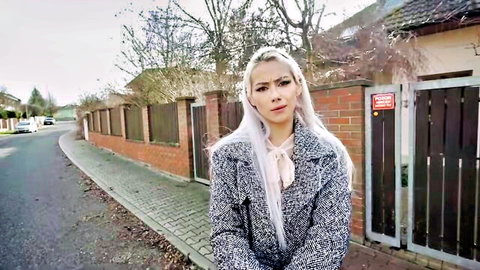 Veronica Leal in gray coat and blouse, standing outdoors in Order To Obey scene