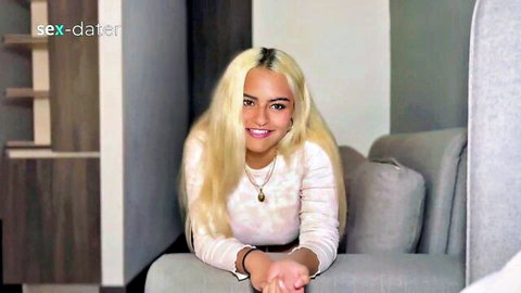 Smiling blonde woman in white top leaning on couch for intense creampie