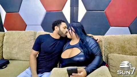 Curvy brunette in sexy leather outfit passionately kissing muscular man