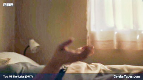 Elisabeth Moss seductive hand reach in intimate bed scene