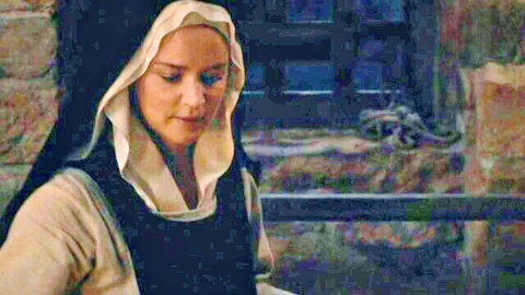 Blonde nun in Benedetta erotic scene, contemplative pose