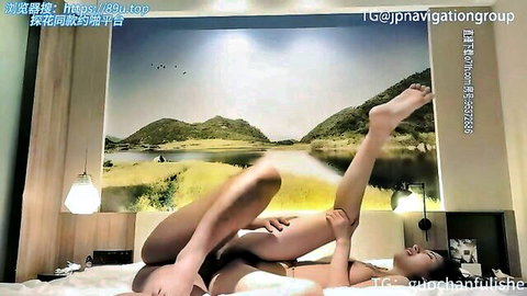 Sexy Chinese call girl posing nude with legs up on bed