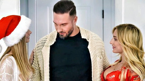 Two sexy blondes in Santa lingerie hats flirt with handsome bearded guy for Christmas threesome tease