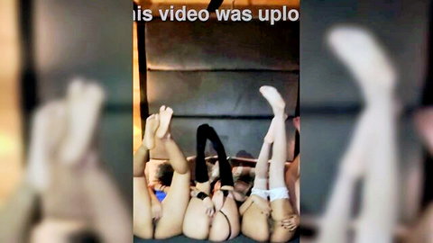 Blurry tanned girls in stockings legs up sharing black dildo in pussies
