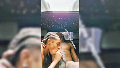 Ebony woman with braids passionately kissing muscular man's torso in intimate embrace