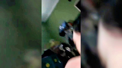 Blurry amateur Asian woman with headphones in green hotel room adjusting blue toy