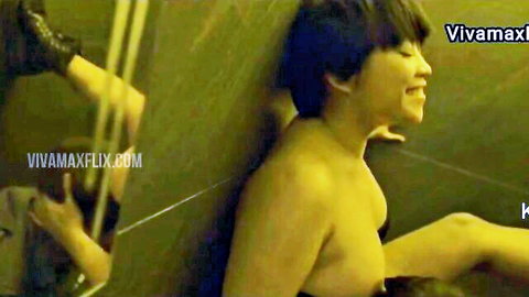 Topless Filipina smiles ecstatically with perky tits exposed against green shower wall