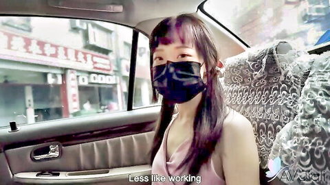 Sexy Asian brunette with small tits in low-cut top and mask teasing in taxi cab
