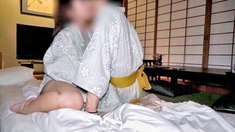 Japanese woman in loose floral kimono exposing thick thighs teasing on bed