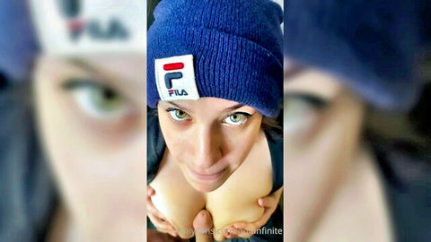 Quinnfinity in blue Fila beanie, teasing deep cleavage close-up