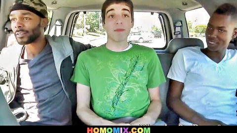 Three young black guys and white twink sitting clothed in van backseat for gay threesome