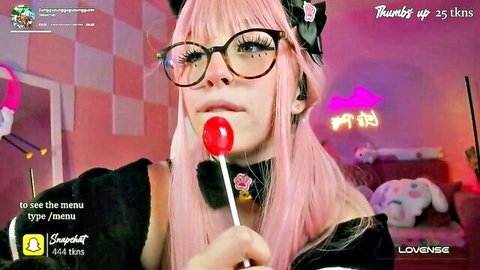 Pink-haired Asian webcam girl with cat ears teasing with lollipop