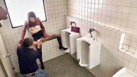Asian babe in stockings lifts leg high in public restroom as guy gropes her thigh under mini skirt