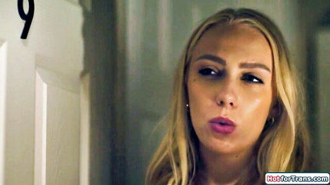 Seductive blonde trans with glossy puckered lips teases blowjob by hotel door