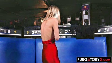 Sexy blonde in tight red dress flaunting bare back and legs in dimly lit club