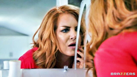 Redhead MILF with shocked O-mouth staring into bathroom mirror Brazzers
