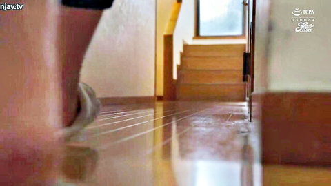 Mature MILF in shorts walking downstairs in hallway scene