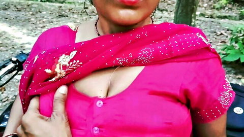 Busty Indian mature MILF teases deep cleavage in pink saree blouse outdoors in forest