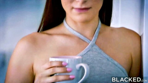 Lana Rhoades holding mug in sexy gray halter top, cleavage tease