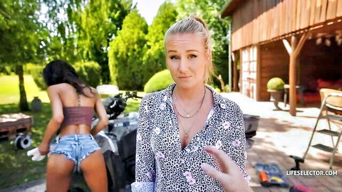 Ebony babe bends over ATV showing juicy ass in tiny denim shorts while blonde friend gestures surprised outdoors