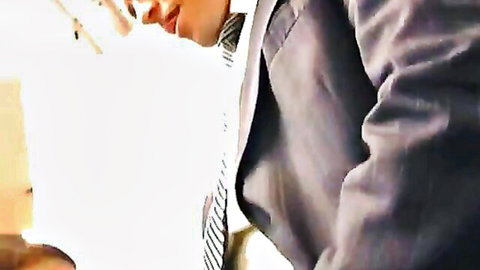 Dan Fisk in suit intense oral performance close-up