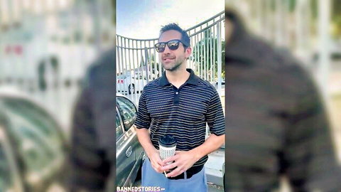 Smiling man in sunglasses and polo shirt holding coffee cup by car outdoors